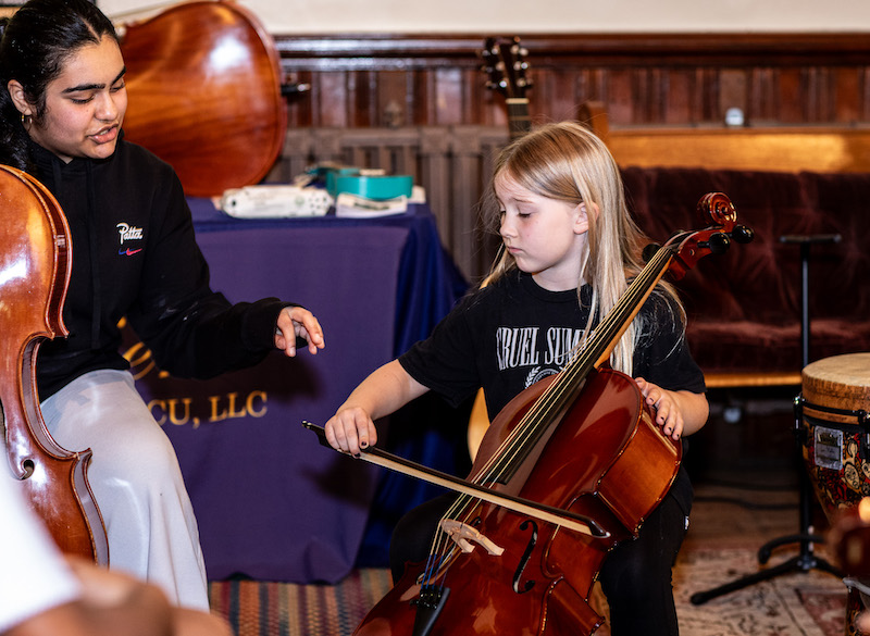 Young girl playing instrument for first time