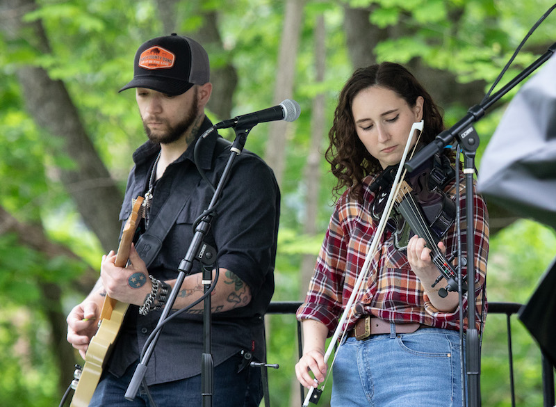 Two musicians on stage with guitar and violin