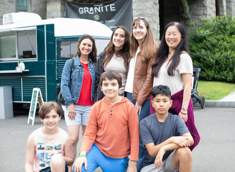 Group of adults and children posed in front of The Granite