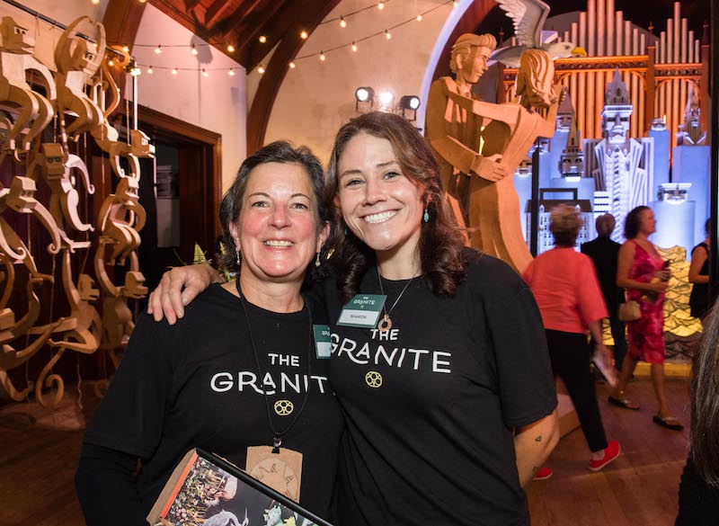 Two female volunteers smiling